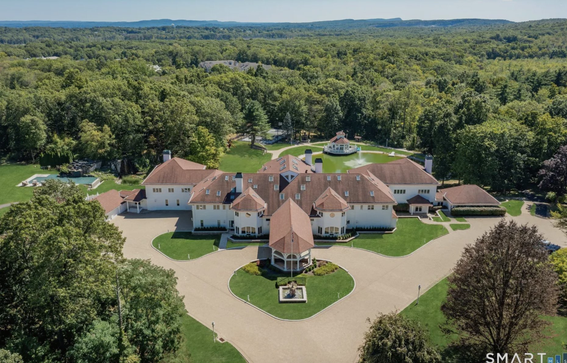 Aerial view of 50 Poplar Hill Drive, Farmington CT, showing the main residence, pond with gazebo, and grounds on 17.59 acres