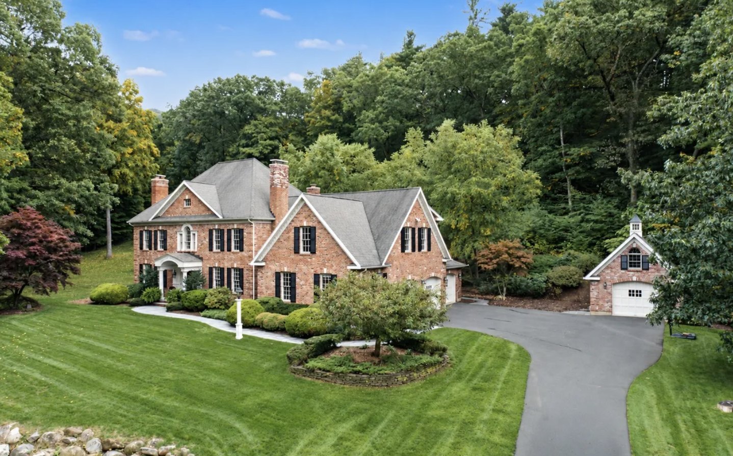 Six bedroom brick colonial home with detached garage on a wooded lot in Avon CT, asking $1,475,000